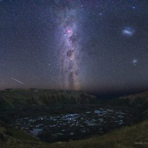 Galactic Trio Above a Volcanic Crater