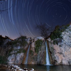 Star trails over twin waterfalls