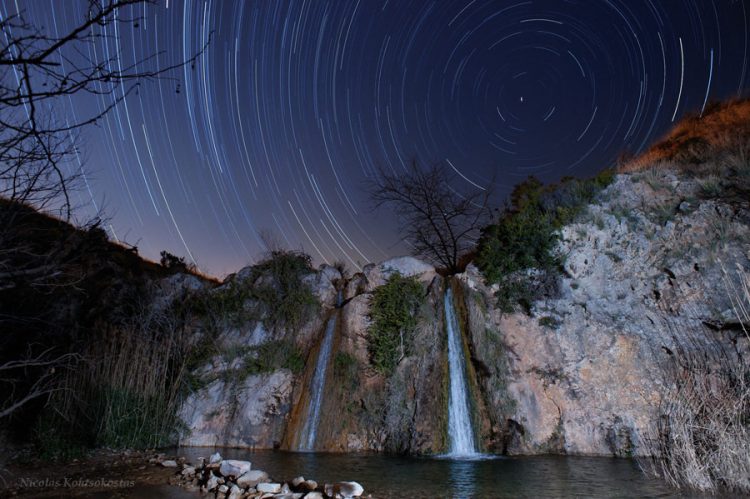 Star trails over twin waterfalls