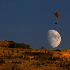 Moon and Paraglider over Mountain