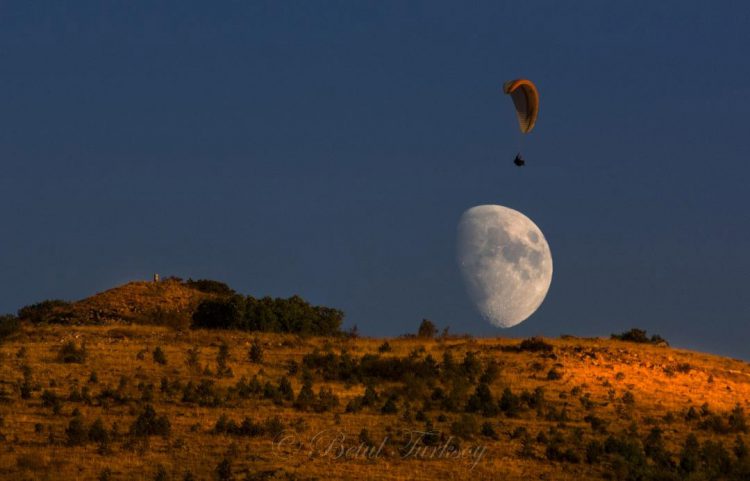 Moon and Paraglider over Mountain