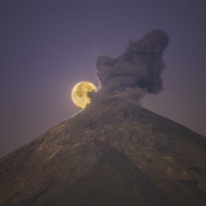 Lunar Eclipse Over Erupting Volcano