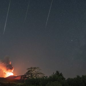 Three Perseids Over Erupting Volcano