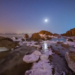 Ice Covered Beach Under Moonlight