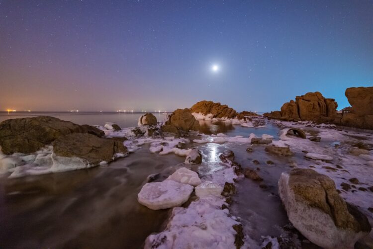 Ice Covered Beach Under Moonlight